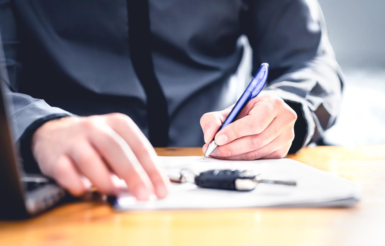 Man signing for auto loan